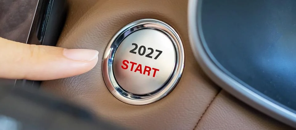 Finger press a car ignition button with 2027 START text inside  automobile... Stock Photos