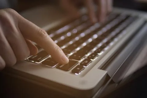 Finger press the delete button on keyboard laptop Stock Photos