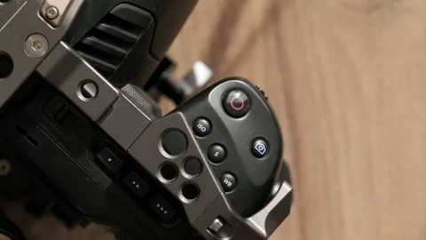 Finger press record button on professional movie camera. Start recording podcast Stock Footage 233388142