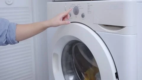Finger press the switch to make the washing machine work. Stock Footage 231582233