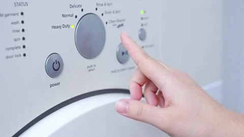 Finger press the switch to make the washing machine work. Stock Footage 231582239
