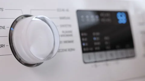 Finger press the switch to make the washing machine work. Home appliances Stock Footage 232007819