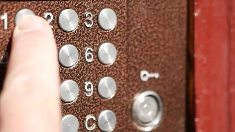 Finger presses aluminum intercom buttons. Man hand enters a code to open door Stock Footage 138598304