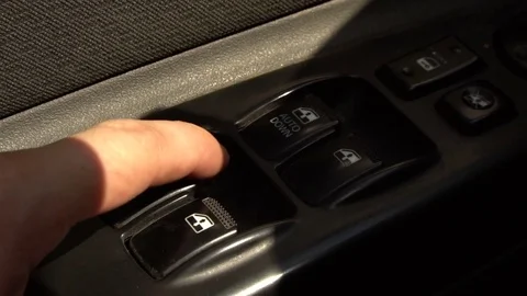 Finger presses the automatic window regulator button in the car. Stock Footage 80059075