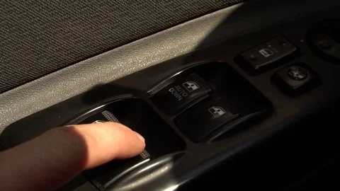 Finger presses the automatic window regulator button in the car. Stock Footage 80059092