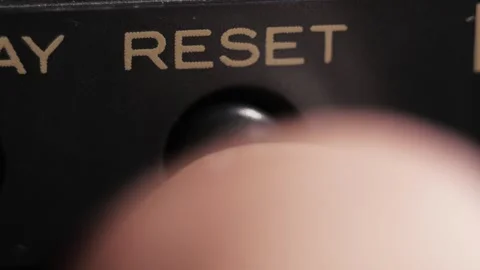 Finger Presses Black Reset Button With Gold Lettering 動画素材 332553969