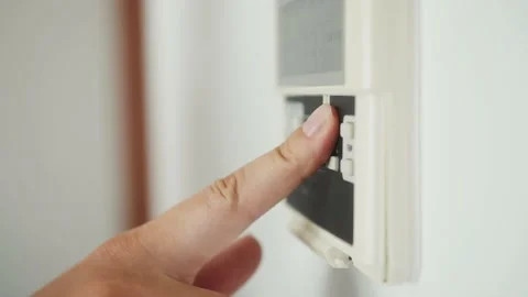 Finger presses the button on air conditioner. Stock Footage 159995669