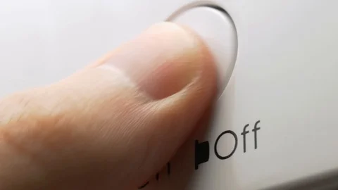 Finger presses on off button on a dishwasher repeatedly macro Stock Footage 124393876