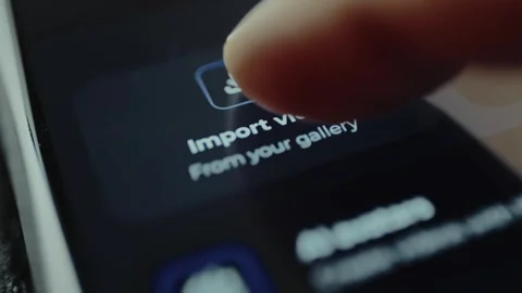 Finger presses the button Import video from your galley within a video editing Stock Footage 328366758