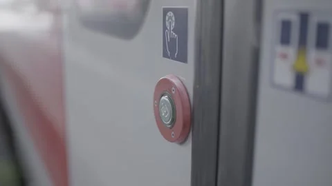 A finger presses a button to open a train door Stock Footage 287726868