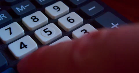 A finger presses the calculator buttons. Close-up shot Stock Footage 318158846