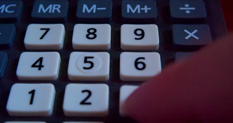 A finger presses the calculator buttons. Close-up shot Stock Footage 318162299
