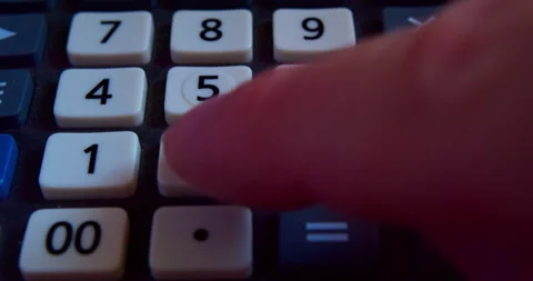 A finger presses the calculator buttons. Close-up shot Stock Footage 318162370