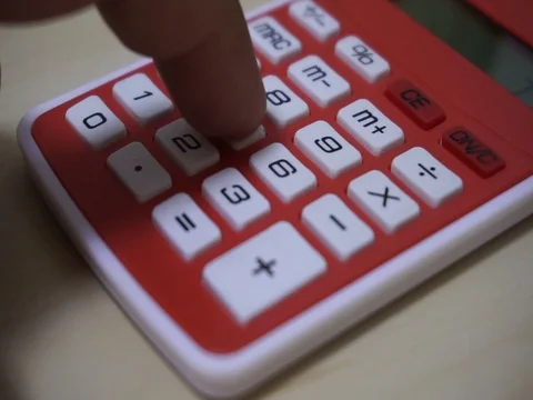 Finger presses the calculator buttons. Stock Footage 77423877