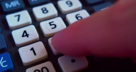 A finger presses the calculator buttons. Stock Footage 318929569