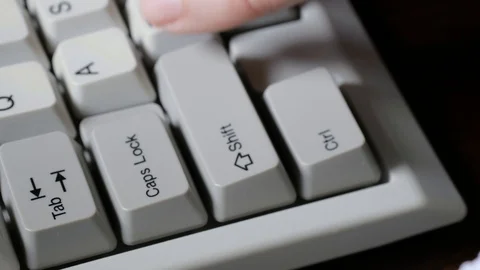 Finger presses CAPS LOCK button on keyboard Stock Footage 121071791