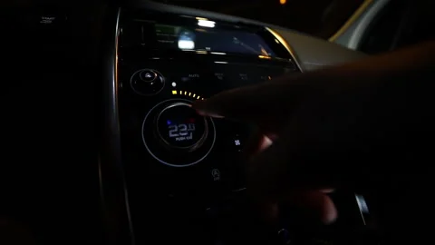 A finger presses the climate control button. The person makes the temperature in Stock Footage 167999641