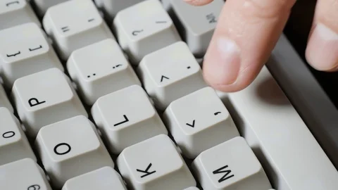 Finger presses comma or < button on keyboard Stockbeeldmateriaal 121072761