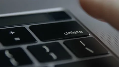 Finger presses the Delete button on keyboard once and several times, close-up Stock Footage 168966442
