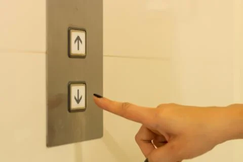 Finger presses the elevator button. hand reaches for the button of the elevat Foto stock