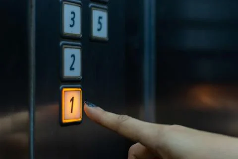 Finger presses the elevator button. hand reaches for the button of the elevat 스톡 사진
