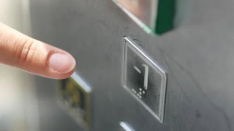 Finger presses elevator button in modern building Stock Footage 310813107