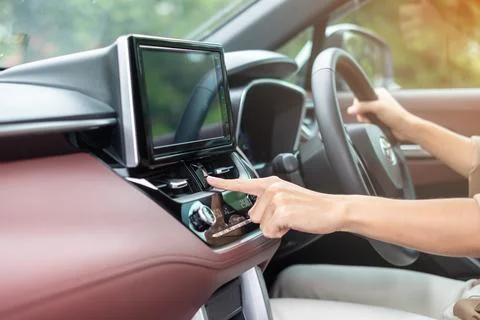 Finger presses the emergency stop button inside the car. Safety and transport Stock Photos