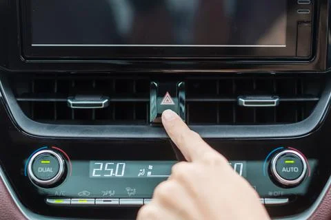 Finger presses the emergency stop button inside the car. Safety and transport Stock Photos