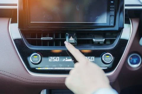 Finger presses the emergency stop button inside the car. Safety and transpo.. Stock Photos