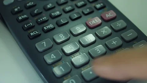 Finger presses the engineering calculator buttons. Closeup shot 動画素材 77406295