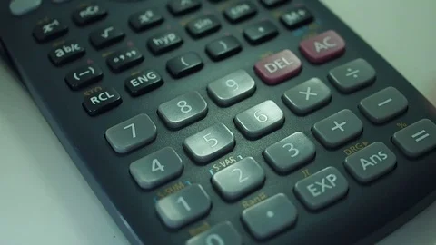 Finger presses the engineering calculator buttons. Closeup shot Stock-Footage 77406300
