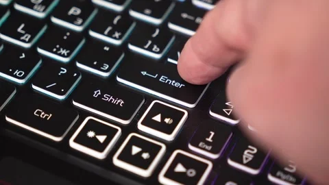 A finger presses the enter key on a keyboard Stock Footage 327451615
