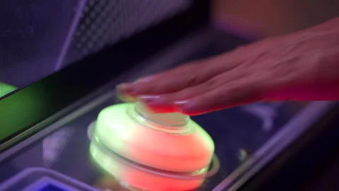 Finger Presses Illuminated Button on Claw Machine at Arcade Stock Footage 313838900