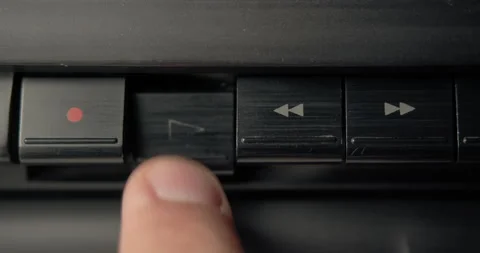 A finger presses the play button on an old cassette tape player. Stock Footage 156172198