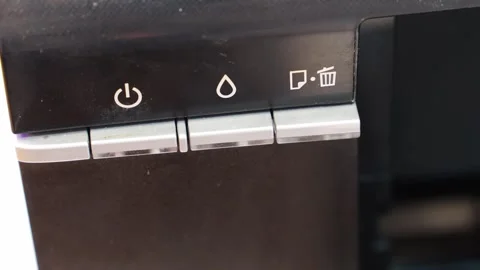 Finger presses the power button on the printer. Stock Footage 286308785