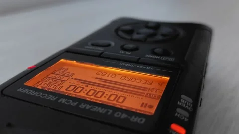 Finger presses record and stop button of digital audio voice dictophone. Screen Stock Footage 220011730