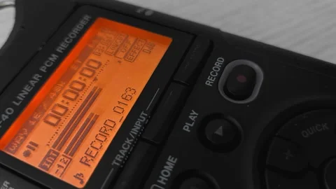 Finger presses record button of digital voice audio dictophone during interview Stock Footage 219774070