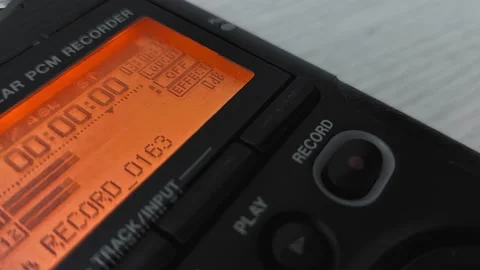 Finger presses record button of digital audio voice dictophone during interview Видео 219938828