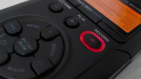 Finger presses record button of digital voice audio dictophone during interview Stock Footage 220012181