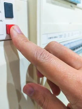 Finger presses a red button on a control panel. Concept of action, control, s Stock Photos
