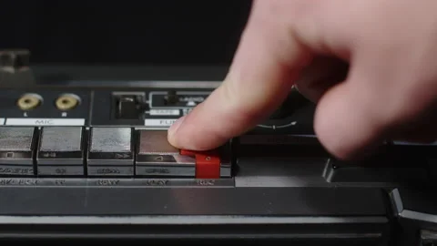 Finger presses the red rivers button and the play button at the same time: macro Stock Footage 170717555