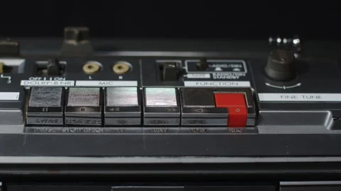 A finger presses the rewind button on an old shiny cassette recorder - close-up Stock Footage 171593943
