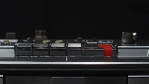 A finger presses the rewind button on an old shiny cassette recorder - close-up Stock Footage 171594136