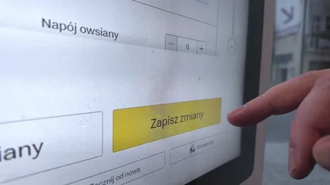 A finger presses the Save changes button on a self-service touchscreen disp.. Stock Footage 318831980