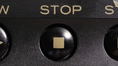 Finger Presses Stop Button With Gold Label On Black Panel Video stock 332562902