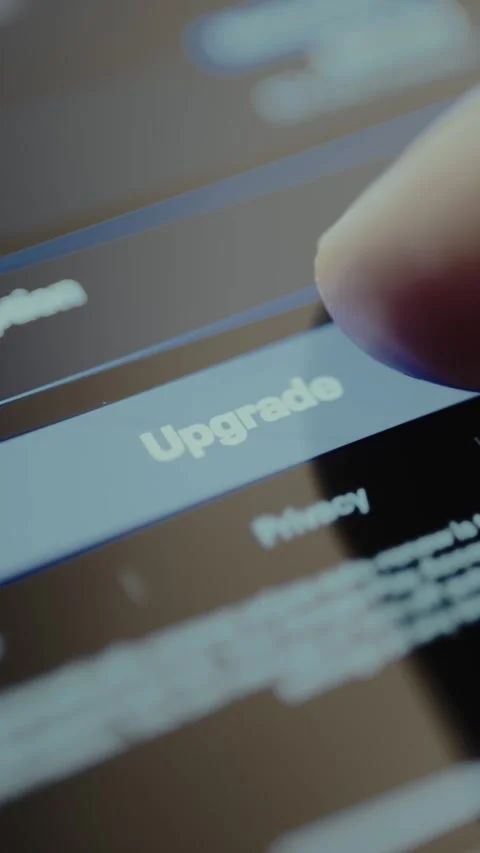 Finger presses the Upgrade button on the screen Stock Footage 328367706