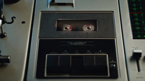 Finger pressing button audio recorder with spinning cassette inside closeup. Video stock 332619150