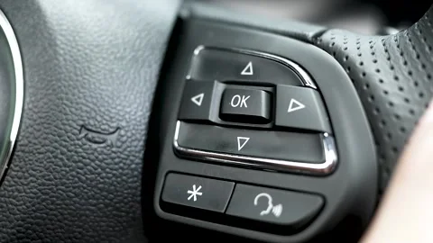 Finger pressing button to control multimedia system on monitor on the steering. Video stock 137773026