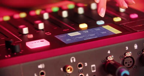 Finger pressing button on digital audio mixer with glowing interface Stock Footage 316248908