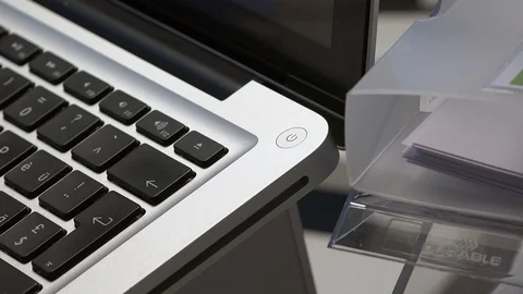 Finger pressing the "on button" on a MacBook Stock Footage 71821152